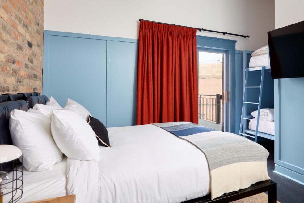 Guest suite at boutique hotel with bed, furniture, and bunk beds made by Morgan Li