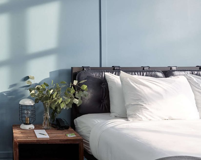Bed, headboard, and casegoods at boutique hotel Wheelhouse Chicago