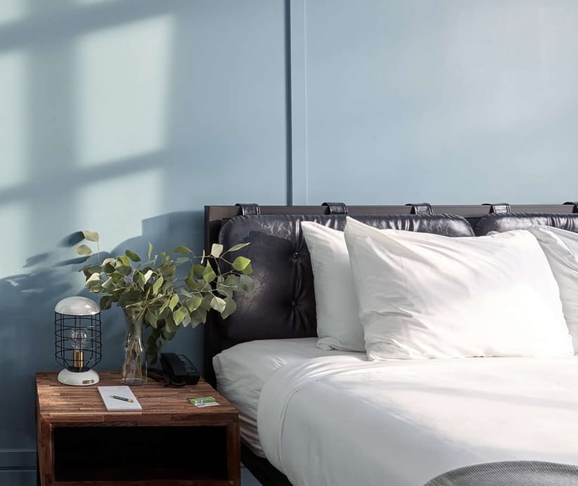 Bed, headboard, and casegoods at boutique hotel Wheelhouse Chicago