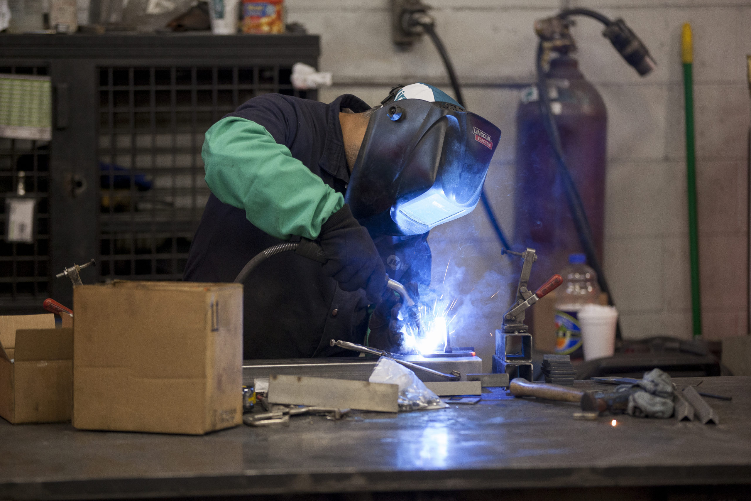 Welder works on metal tube